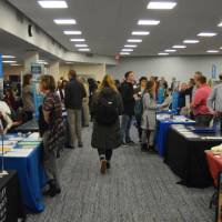 An aisle of booths set up at the Academic Major Fair.